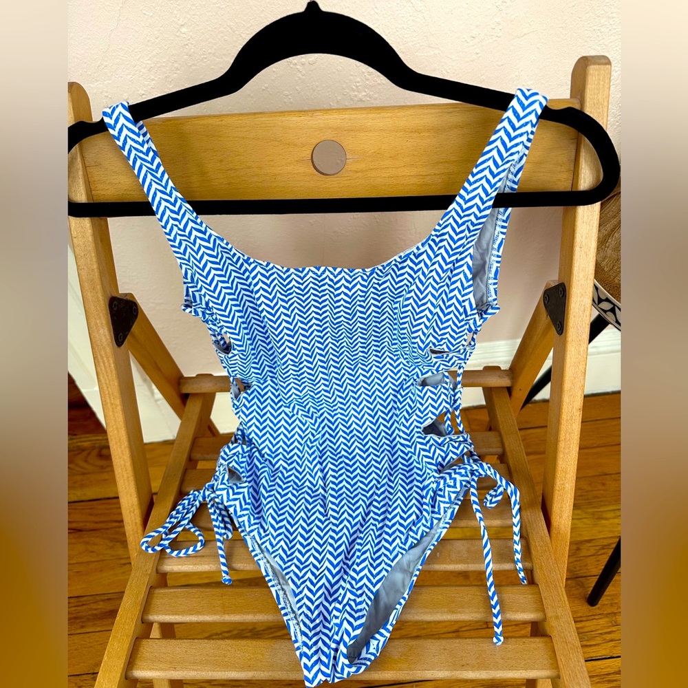 One piece swim wear, size S/M, With open sides, tighten with string, backless